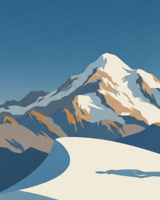 The snowy peak with ochre rocks and the long shadow across the snow