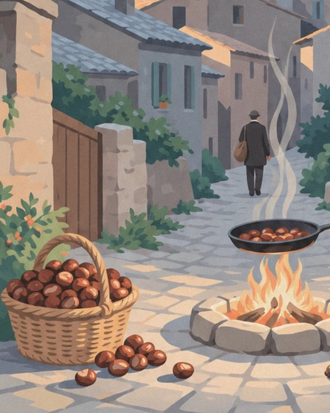 Ein Korb Kastanien neben einer Pfanne über dem Feuer in einer Gasse der Castagniccia