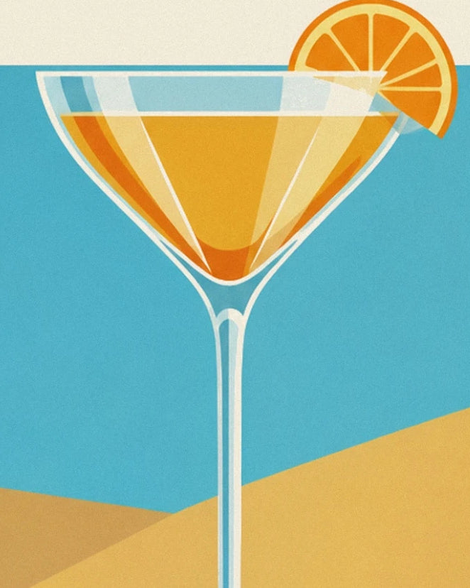 The crystal coupe holding a golden cocktail, garnished with an orange slice against a blue background