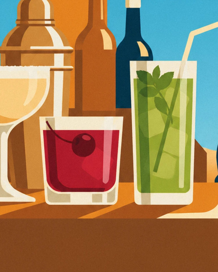 A red drink with a cherry and a mint mojito, in front of the bottles at the bar