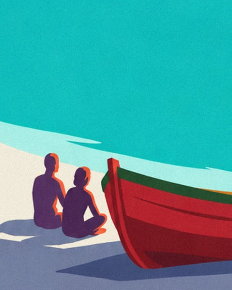 A couple sitting on the white sand beside a red rowing boat with green trim