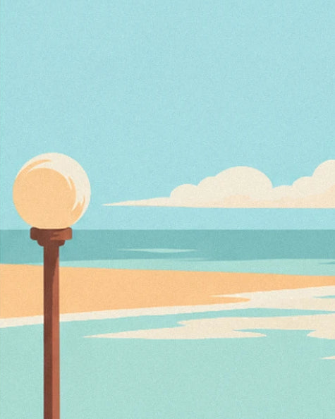 The lamppost with a golden globe facing the turquoise sea, with the orange sandy beach beyond