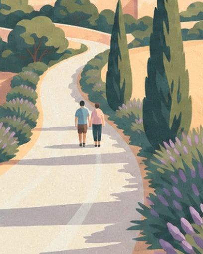 A couple holding hands on the white path, between cypress trees and lavender