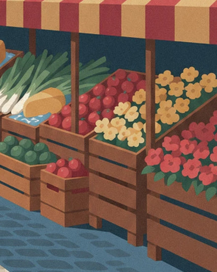 Crates of vegetables and yellow and red flowers beneath the striped awning