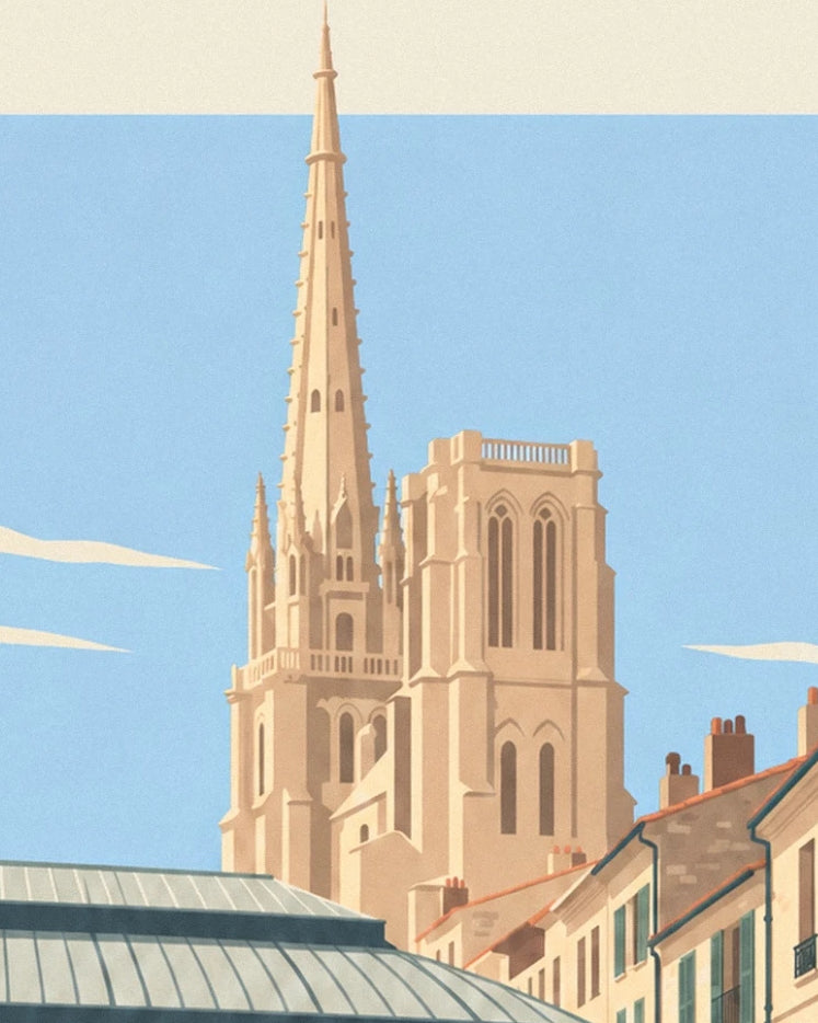 The flèche Saint-Michel above the rooftops of Bordeaux against a blue sky