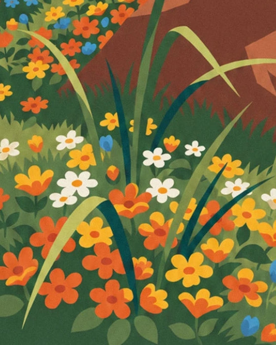 Orange, yellow and white flowers among the long grass at the foot of the rock