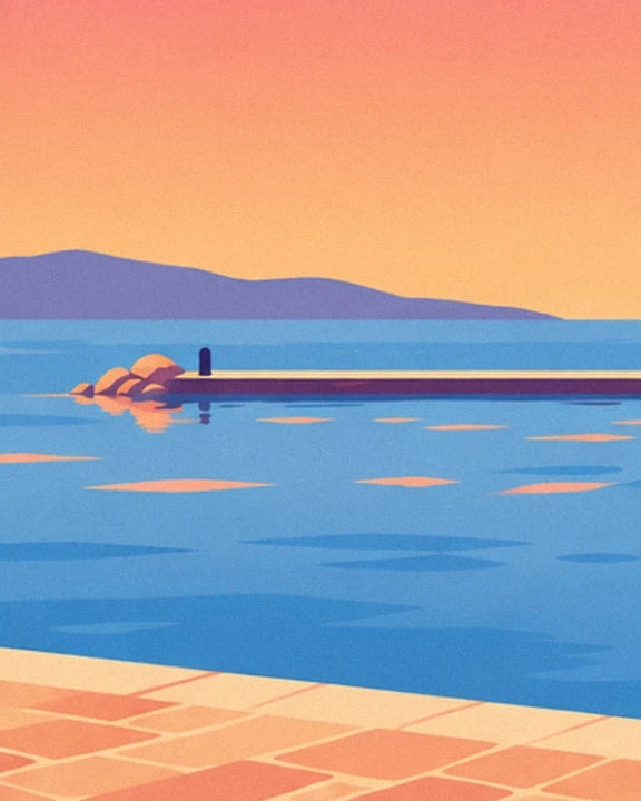 The rock-lined jetty between the blue sea and hills beneath an orange sky