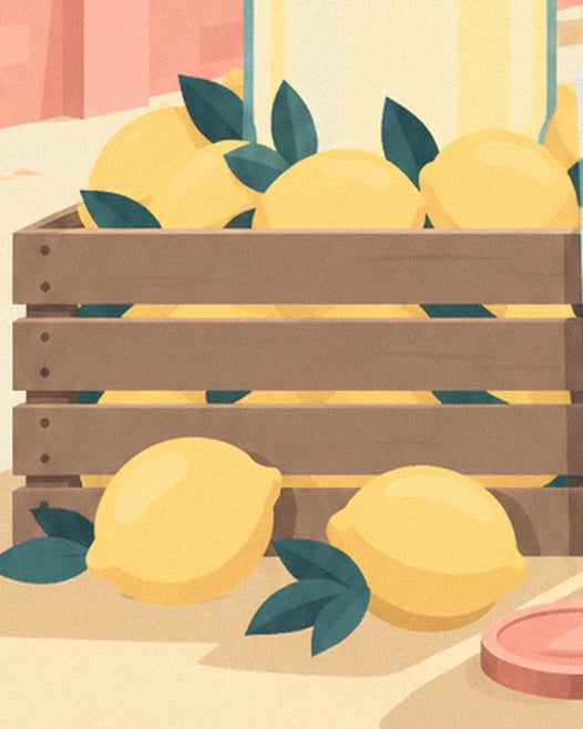 The wooden crate filled with lemons, with 2 lemons and their leaves on the table