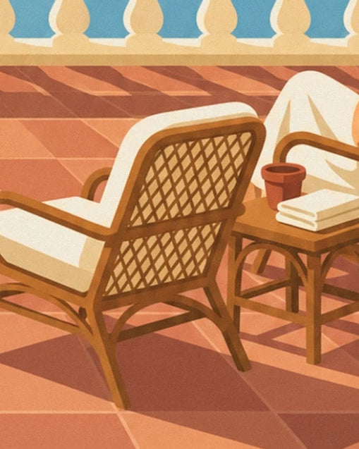 Fauteuil en rotin à coussin crème, table d'appoint et pot en terre cuite sur le carrelage orangé