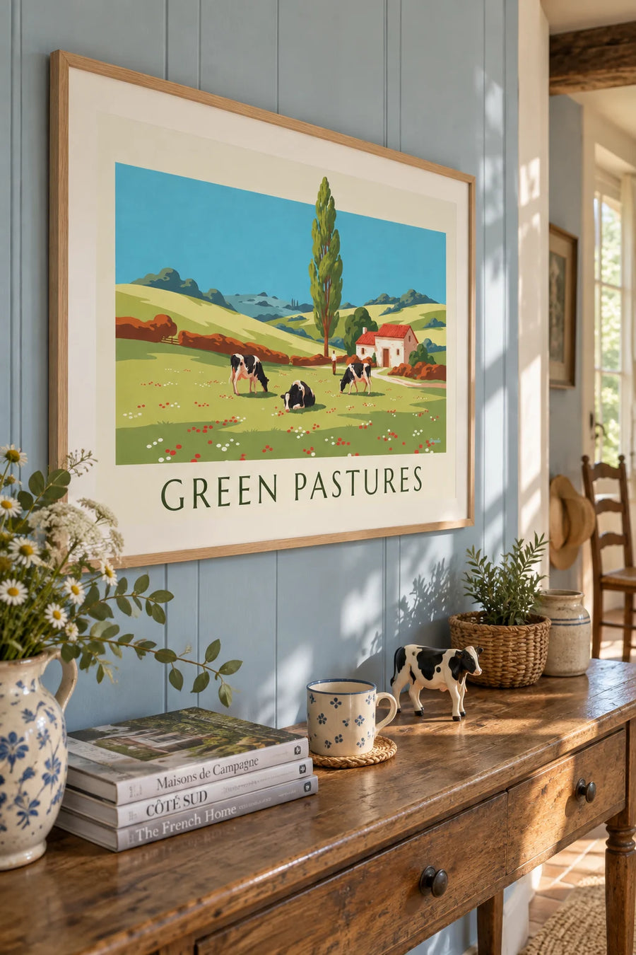 Poster of cows roaming free in rolling countryside: framed on the wall
