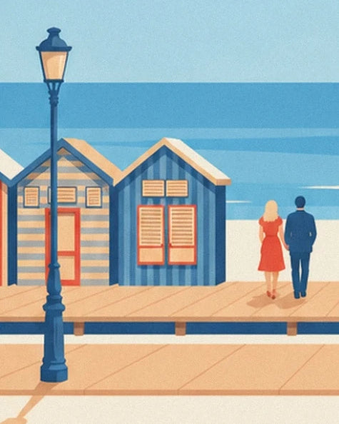 Ein Paar neben den blauen Strandkabinen und einer Straßenlaterne auf der Promenade von Deauville