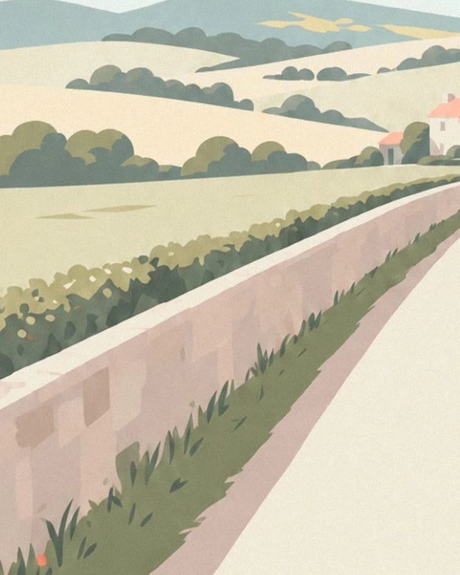 The low wall edged with grasses along the path, in front of fields and houses