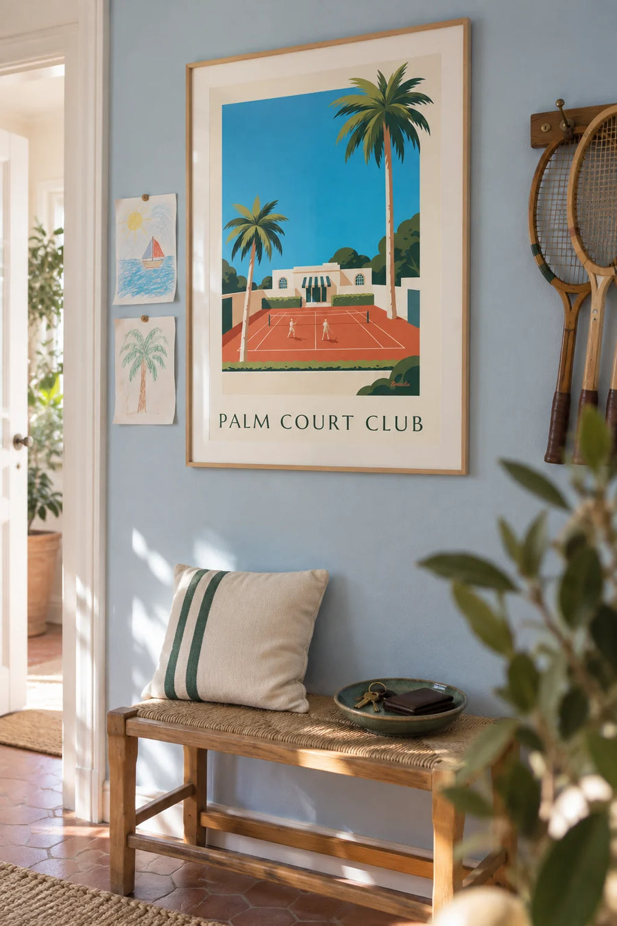 Poster of a tennis club and clay court lined with palm trees: framed on the wall