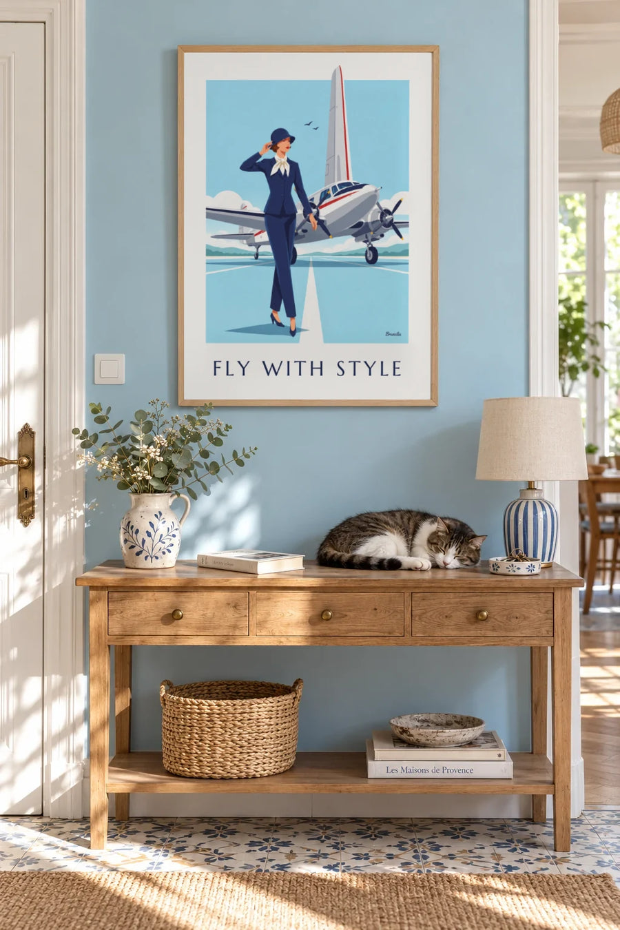 Poster of an elegant woman in front of a twin-engine propeller plane: framed on the wall