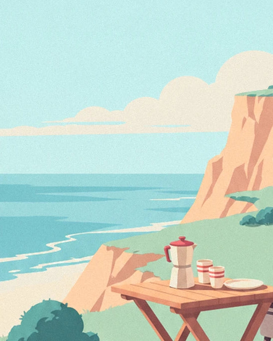La cafetière et les 2 tasses sur la table en bois, face à la mer et aux falaises