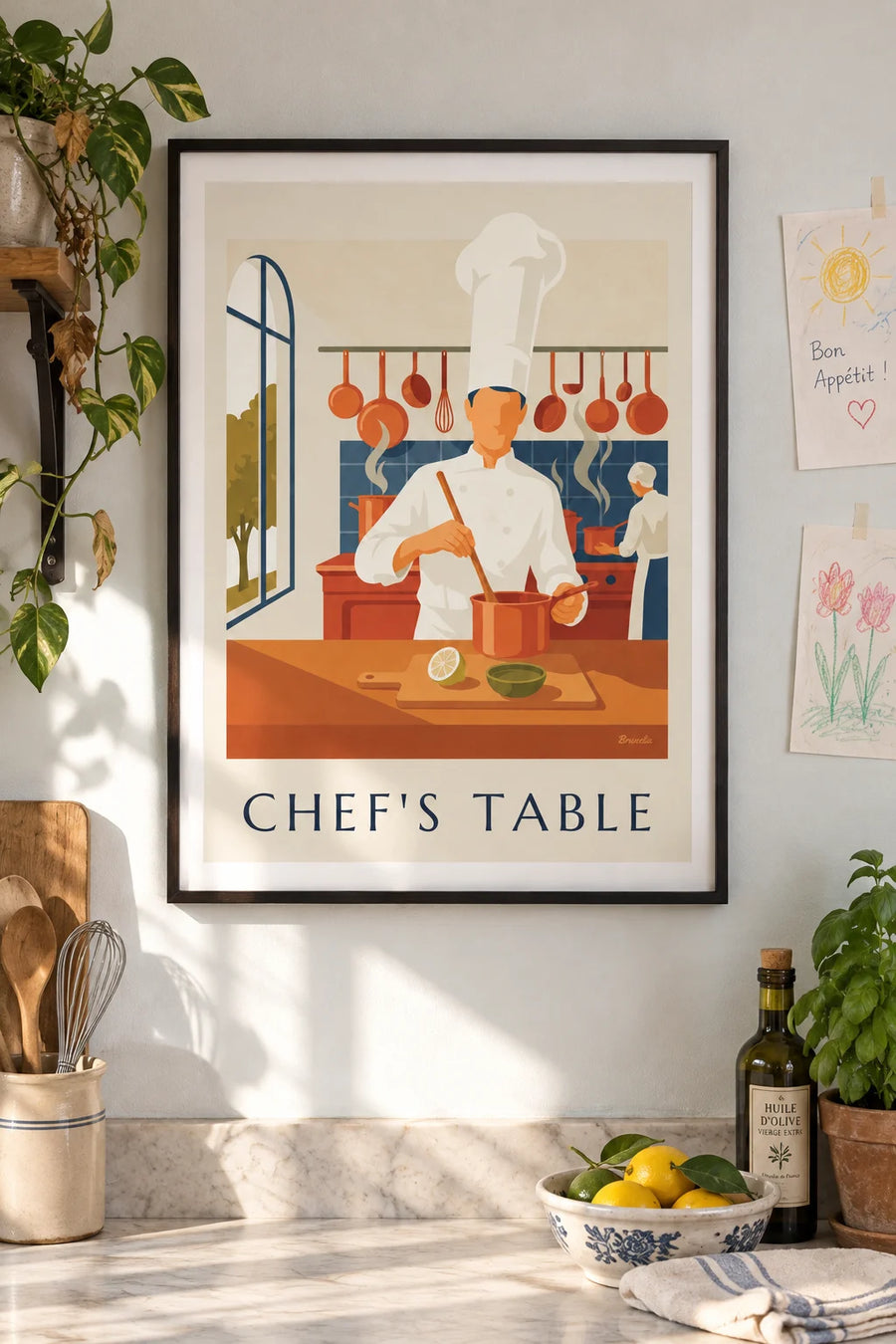 Poster of a chef in a toque surrounded by copper pots: framed on the wall
