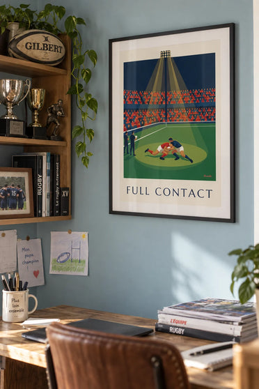 Poster of a rugby tackle mid-run in the stadium: framed on the wall