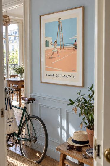 Poster of a tennis player in a hat and fitted dress: framed on the wall